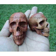 human skull carving brownwood